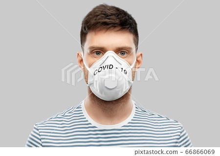 young man in face protective mask or respirator young man in face protective mask or respirator 66866069