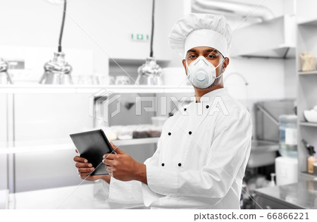 chef in respirator with tablet pc at kitchen chef in respirator with tablet pc at kitchen 66866221