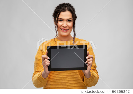 happy young woman showing tablet pc computer 66866242