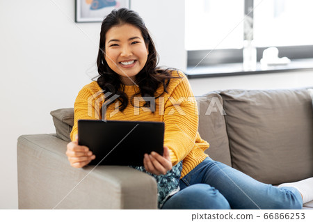 asian young woman with tablet pc computer at home asian young woman with tablet pc computer at home 66866253