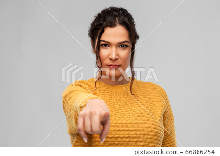 young woman pointing finger to camera young woman pointing finger to camera 66866254