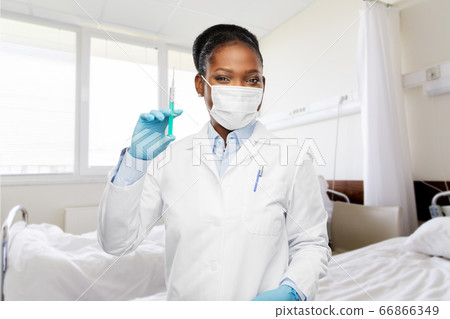 african american doctor with syringe at hospital 66866349