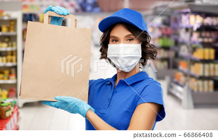 delivery woman in mask with food in bag at store 66866408
