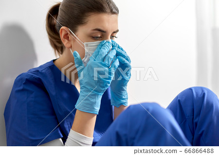 sad doctor or nurse in protective face mask sad doctor or nurse in protective face mask 66866488