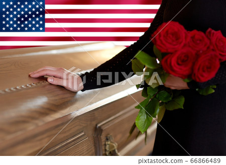 woman with red roses and coffin over american flag woman with red roses and coffin over american flag 66866489