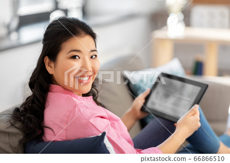 asian young woman with tablet pc computer at home asian young woman with tablet pc computer at home 66866510