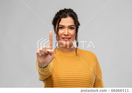 happy woman in pullover showing one finger 66866511