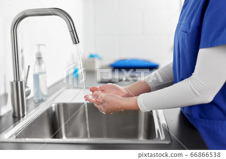 doctor or nurse washing hands with liquid soap 66866538