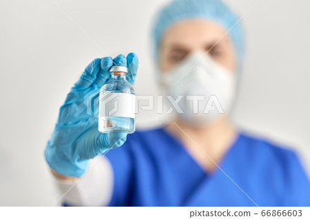 close up of doctor's hand with bottle of medicine close up of doctor's hand with bottle of medicine 66866603