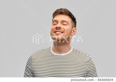 smiling young man in striped t-shirt breathing 66866604