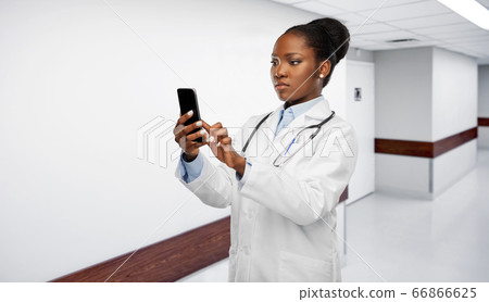 african american female doctor with smartphone african american female doctor with smartphone 66866625