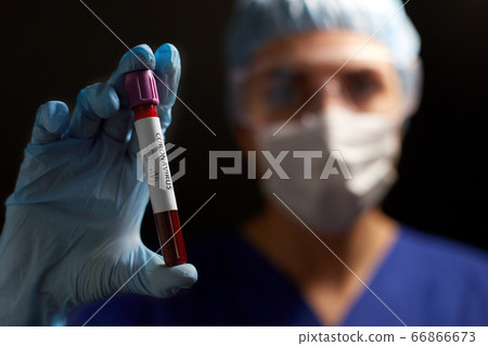doctor holding beaker with coronavirus blood test doctor holding beaker with coronavirus blood test 66866673