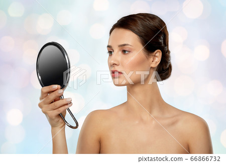 beautiful young woman looking to mirror beautiful young woman looking to mirror 66866732