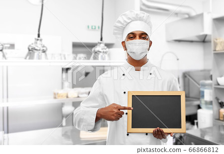 chef in face mask with chalkboard at kitchen chef in face mask with chalkboard at kitchen 66866812