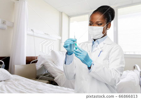 african american doctor with syringe at hospital african american doctor with syringe at hospital 66866813