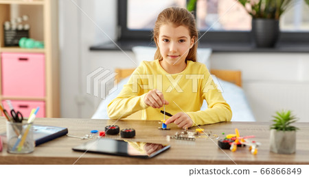 happy girl playing with robotics kit at home happy girl playing with robotics kit at home 66866849