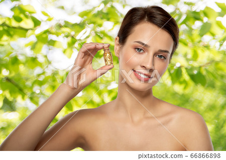 beautiful young woman with gold facial mask beautiful young woman with gold facial mask 66866898