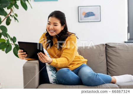 asian young woman with tablet pc computer at home asian young woman with tablet pc computer at home 66867324