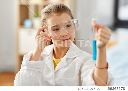 girl with test tube studying chemistry at home girl with test tube studying chemistry at home 66867378