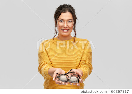 happy smiling young woman with glasses 66867517