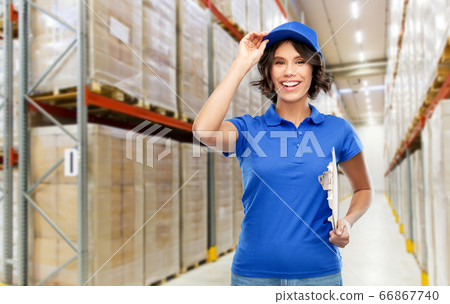 happy delivery girl with clipboard at warehouse 66867740