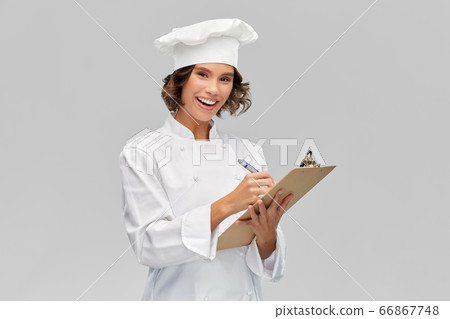 smiling female chef in toque with clipboard 66867748