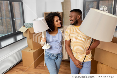 happy couple packing boxes and moving to new home 66867758