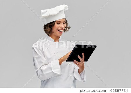 smiling female chef in toque with tablet computer 66867784