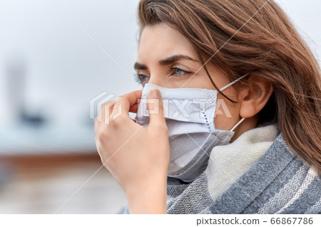 young woman wearing protective medical mask 66867786