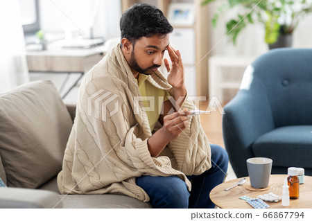 sick man measuring temperature by thermometer sick man measuring temperature by thermometer 66867794