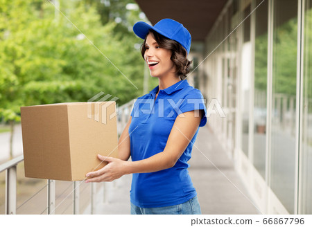 happy delivery girl with parcel box in blue happy delivery girl with parcel box in blue 66867796