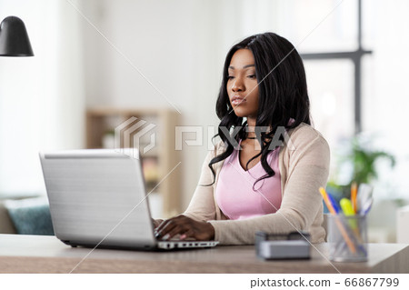 woman with laptop working at home office woman with laptop working at home office 66867799