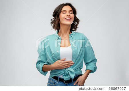 happy full young woman touching her tummy happy full young woman touching her tummy 66867927