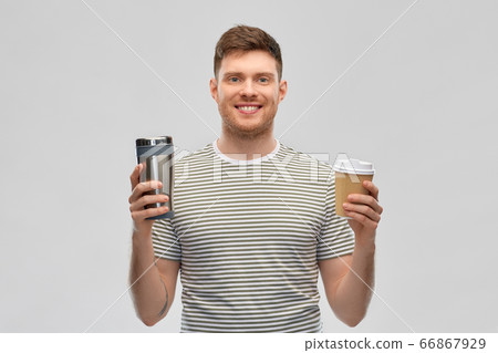 man comparing thermo cup or tumbler and coffee cup man comparing thermo cup or tumbler and coffee cup 66867929