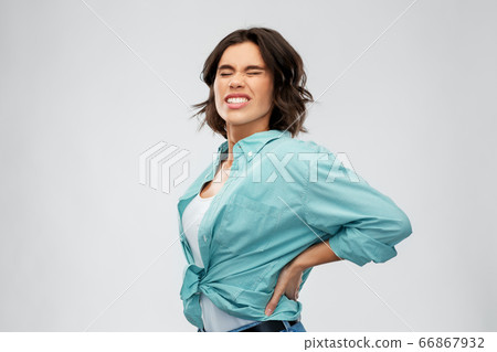 young woman suffering from backache young woman suffering from backache 66867932
