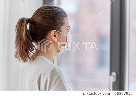 sick young woman wearing protective medical mask sick young woman wearing protective medical mask 66867933