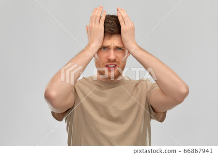 unhappy man suffering from headache 66867941