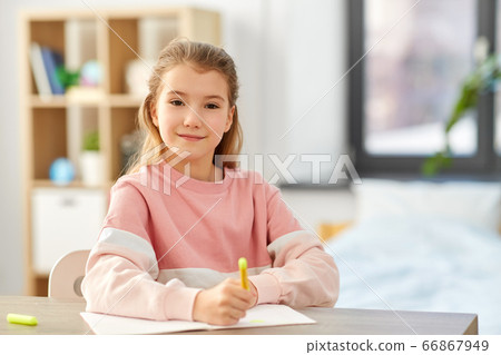 girl with notebook and marker drawing at home 66867949