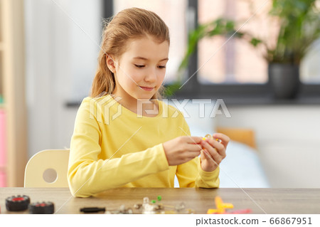 happy girl playing with robotics kit at home happy girl playing with robotics kit at home 66867951