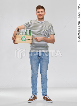 smiling young man sorting glass waste smiling young man sorting glass waste 66867952