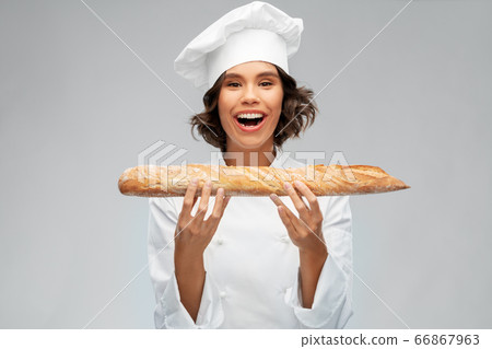 happy female chef with french bread or baguette happy female chef with french bread or baguette 66867963