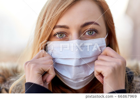 young woman wearing protective medical mask young woman wearing protective medical mask 66867969