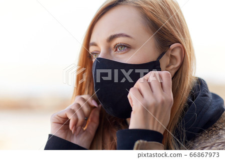 woman wearing protective reusable barrier mask 66867973