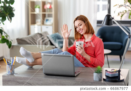 woman with laptop having video call at home office woman with laptop having video call at home office 66867977