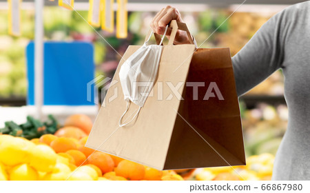 woman with shopping bag and mask at grocery 66867980