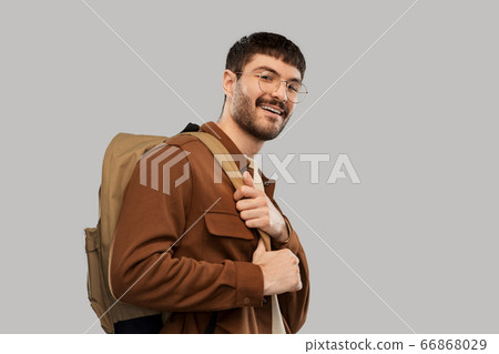 smiling young man in glasses with backpack smiling young man in glasses with backpack 66868029