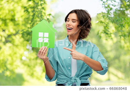 happy woman with green house on natural background happy woman with green house on natural background 66868048