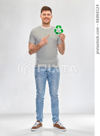 smiling young man holding green recycling sign 66868124