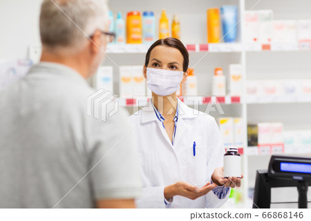 apothecary in mask showing drug to man at pharmacy apothecary in mask showing drug to man at pharmacy 66868146