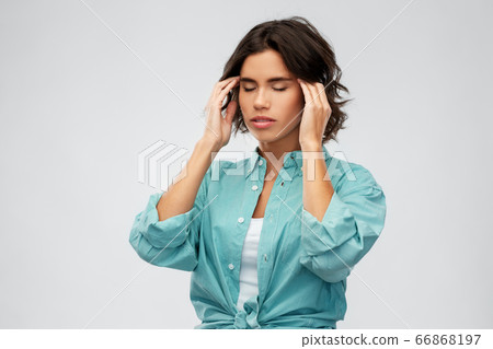 woman having headache holding to her head woman having headache holding to her head 66868197